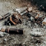 cigarette buts on brown soil