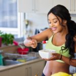 woman eating strawberry in the kitchen