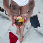 person holding cup filled with brown liquid