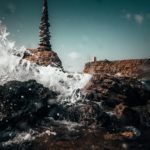 ocean water splashing on rocks