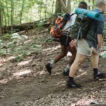 traveling diverse males walking in forest