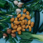 close up shot of variety of vegetables on a blue surface