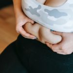anonymous overweight woman touching tummy during training