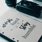 notebook and photo camera on table