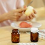 woman suffering from disease at table with medicines