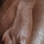 crop black model with shiny delicate skin