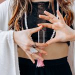 woman in black and white stripe dress with silver and diamond studded bracelet
